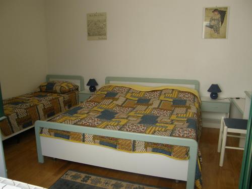 a bedroom with two beds and a table with a chair at Marina Apartment in Crikvenica