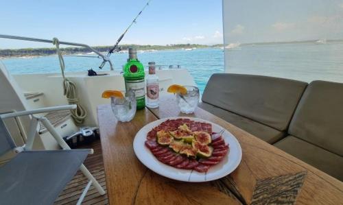 a plate of food on a table on a boat at Prestige 500 Fly in Nettuno