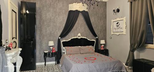 a bedroom with a bed with a black and white canopy at Anzio d'aMare in Anzio