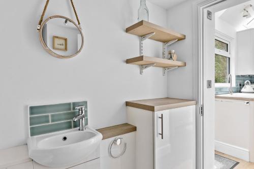 a bathroom with a sink and a mirror at River Retreat in Kingswear