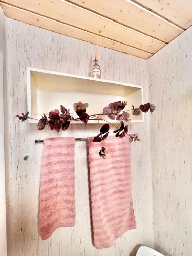 two towels are hanging on a shelf in a bathroom at VB Central Apartment in Vejle