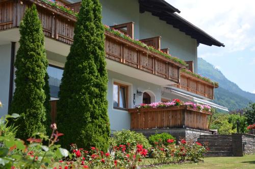 a house with a balcony with flowers on it at Landhaus Königsreiner in Kolbnitz