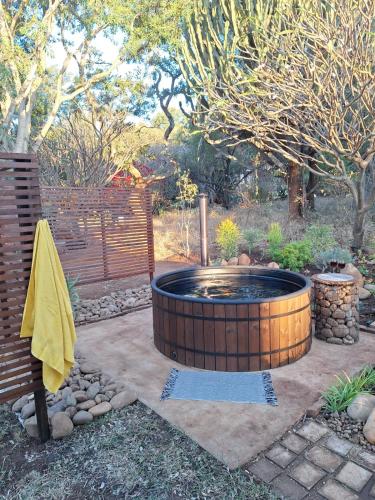 a large hot tub in a yard with a fence at The Bird House in Kampersrus AH