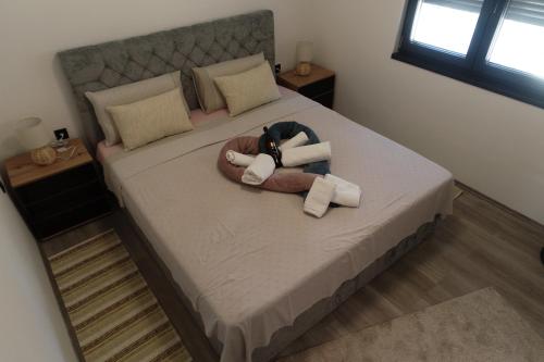 a bedroom with a large bed with a towel on it at Villa Petrovic in Fažana