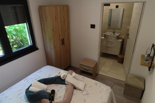 a person laying on a bed in a bedroom at Villa Petrovic in Fažana