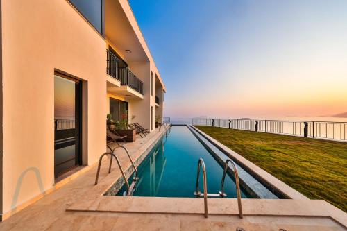 a swimming pool in a building with a view of the ocean at Lyxos Hotel in Kas