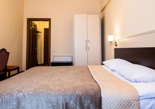 a bedroom with a large bed with white pillows at Ukraine Hotel in Kyiv