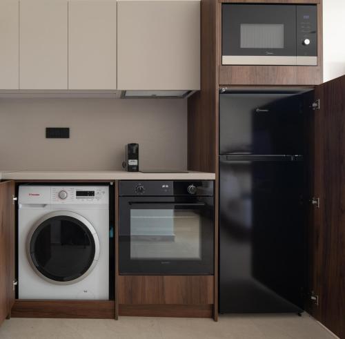 a kitchen with a microwave oven and a dishwasher at Vista Luxury Suites in Neos Marmaras