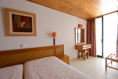 En eller flere senge i et værelse på Apartamentos Tio Papel