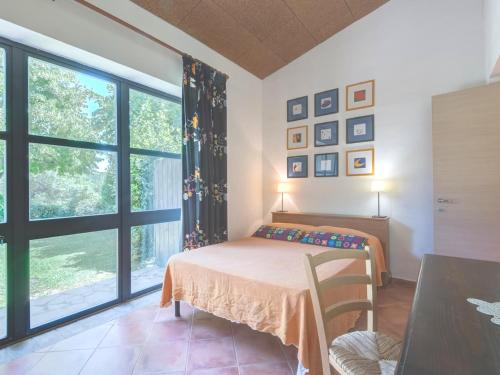 a bedroom with a bed and a large window at Grande, bella villa in Toscana vicino al mare in Capalbio