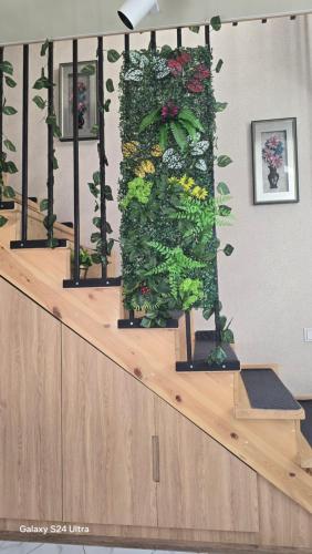 a stairway with a vertical garden of flowers and plants at Maries apartment in Tbilisi City