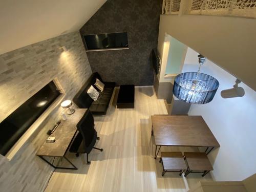 an overhead view of a living room with a table and chairs at Shibuya Stay Tokyo A204 in Tokyo