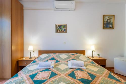 een slaapkamer met een bed met twee kussens erop bij Garden Rooms Chiara in Poreč