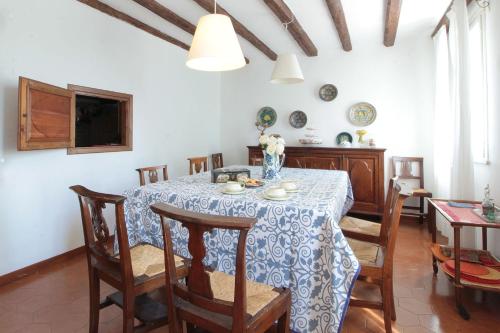 a dining room table with a blue and white table cloth at Ballo Delle Streghe in Montebelluna
