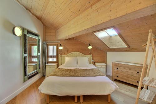 a bedroom with a bed and a wooden ceiling at ARC 1950, Appartement 2 chambres, 6 personnes, Exposition Sud, SAUNA, HAMMAM, JACUZZI, PISCINE in Arc 1950
