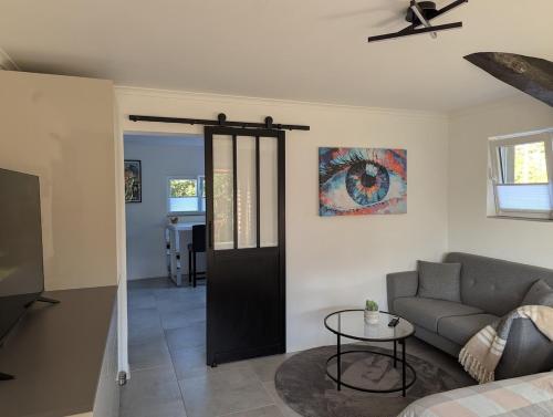 a living room with a couch and a table at Tranquillity in a modern unit in Bazugues
