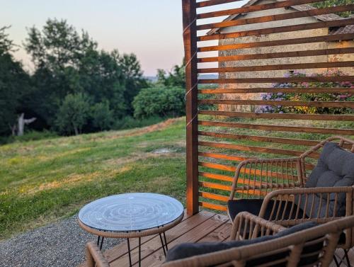 a patio with a table and chairs and a fence at Tranquillity in a modern unit in Bazugues