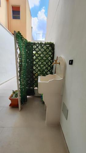a bathroom with a toilet and a sink on a balcony at Casa Marcel in Ugento