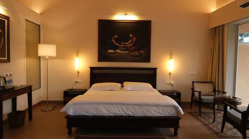 a bedroom with a large bed with two pillows at The Riverstone Agro Farm in Vajapūr