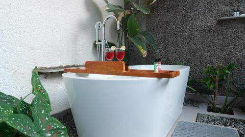 a toilet with two wine glasses on top of it at The Riverstone Agro Farm in Vajapūr