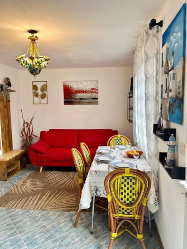 un salon avec un canapé rouge et une table dans l'établissement Charming mediterranean house, à Villelongue-de-la-Salanque