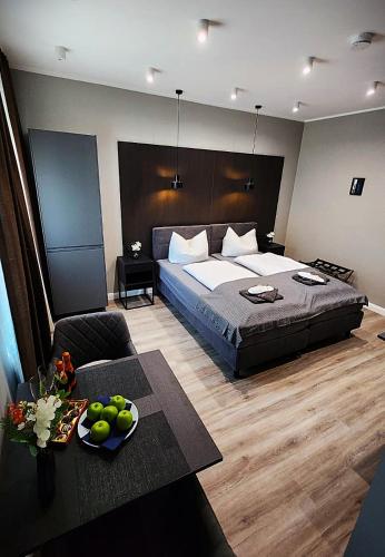 a bedroom with a large bed and a couch at Neueröffnung Liro Hotel Mönchengladbach in Mönchengladbach