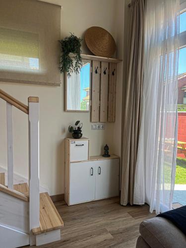 a living room with a staircase and a window at Apartamento Costa Quebrada in Liencres