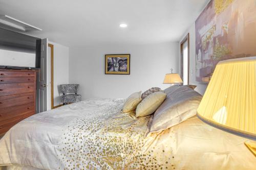 a bedroom with a large bed with pillows at 1 Mi to Shore Lake Michigan Retreat with Game Room! in Two Rivers