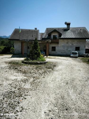 a house with a christmas tree in a gravel driveway at Domaine Les Trois Biches in Groisy