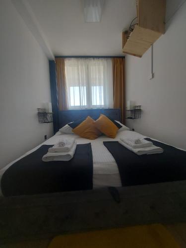 a bedroom with a large bed with towels on it at Apartament Dziesiątka in Bolesławiec