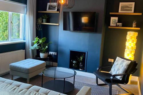 a living room with a couch and a fire place at Carrick Retreat - Free off street parking in Carrickfergus