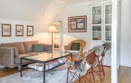 a living room with a couch and a table and chairs at 3 Bedroom Amazing Home In Højby in Højby