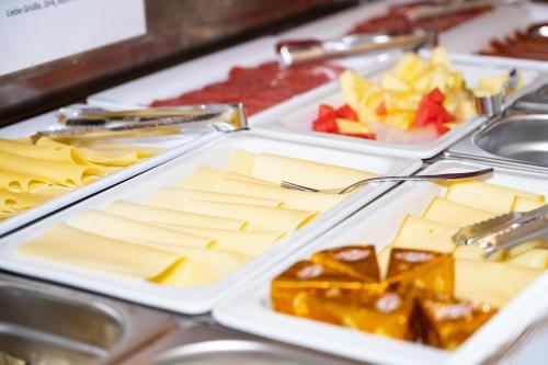 three trays of cheese and fruit on a table at Magali's, Bed & Breakfast - inclusive Summer Card in Zell am See