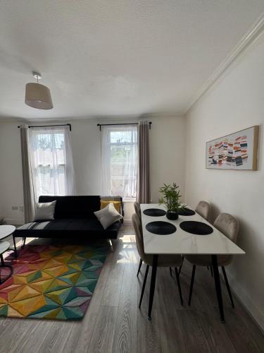 una sala de estar con un sofá y una mesa en Tranquil 2BR in Thornton Heath, en Thornton Heath