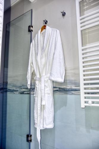 a white robe on a mannequin in a window at La Villa Del Mar in Agadir