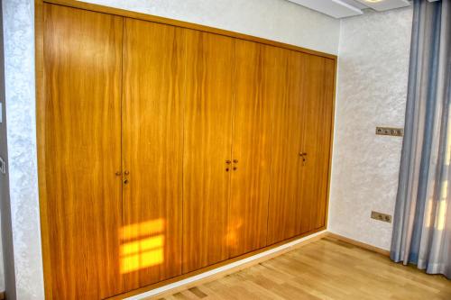 a large wooden closet with two doors in a room at La Villa Del Mar in Agadir