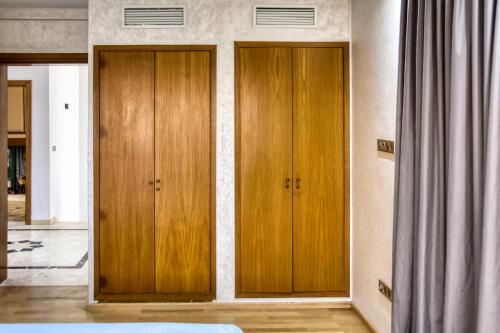 two wooden cabinets in a room with a curtain at La Villa Del Mar in Agadir