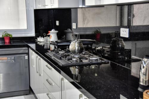 a kitchen with a stove with pots and pans on it at La Villa Del Mar in Agadir