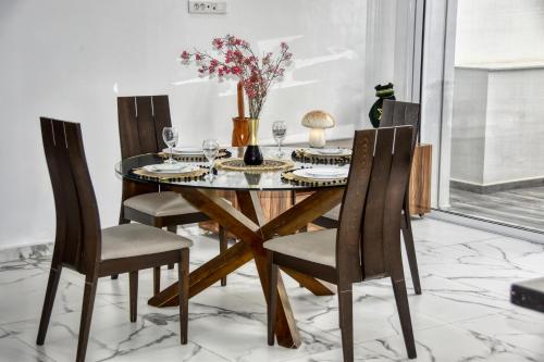 a dining room with a table and four chairs at La Villa Del Mar in Agadir