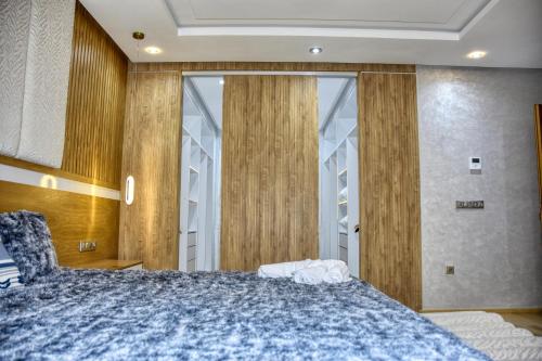 a bedroom with a large bed and a large window at La Villa Del Mar in Agadir