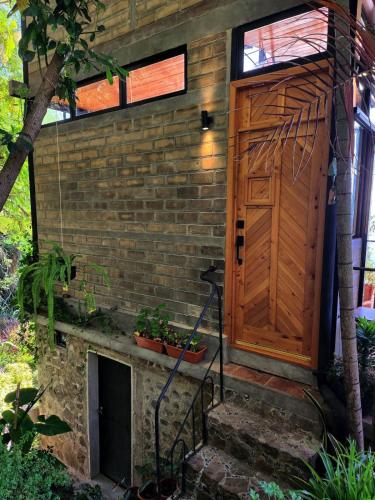 a brick house with a wooden door and stairs at Luxury Casa Árbol Amazing View in Jaibalito