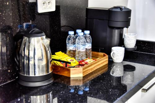 a counter with bottles of water and a coffee maker at La Villa Del Mar in Agadir