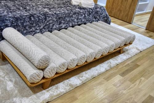a bed with a wooden frame on a rug at La Villa Del Mar in Agadir