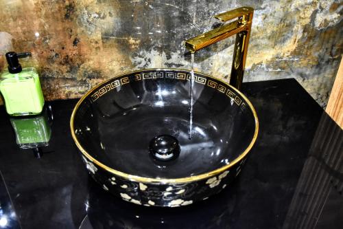 a bathroom sink with water coming from a faucet at La Villa Del Mar in Agadir