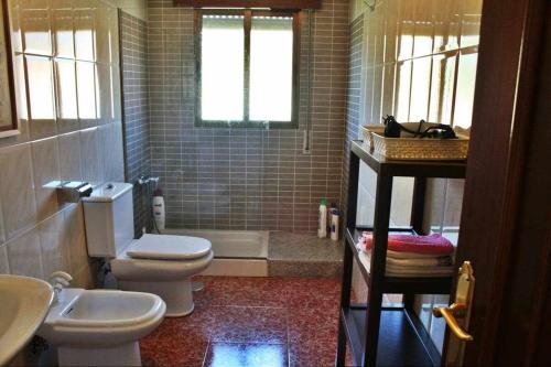a bathroom with a toilet and a sink and a tub at Casalvito in Rial