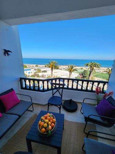 a balcony with a bowl of fruit on a table at la symphonie marine in La Marsa