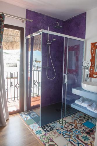 a bathroom with a shower with a glass enclosure at Alhanía Vejer in Vejer de la Frontera