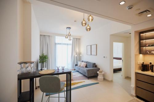 a living room with a table and a couch at Stylish 1BR Warm & Curated Interiors in Dubai