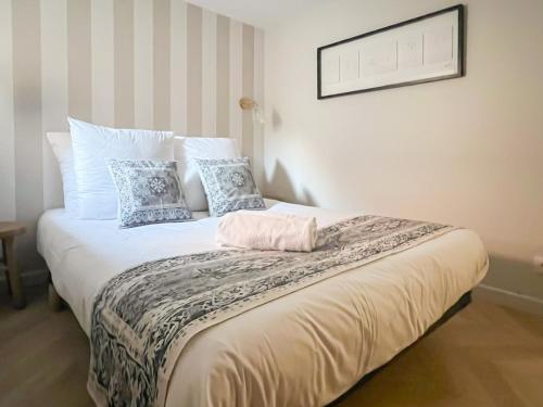 a bedroom with a large bed with blue and white pillows at L Esperance rue du paquier in Annecy