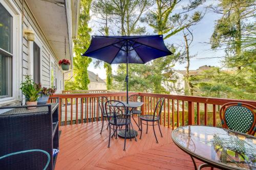 a patio with a table and chairs and an umbrella at 2 Blocks to Beach Walkable Woodmont Village Home in Milford